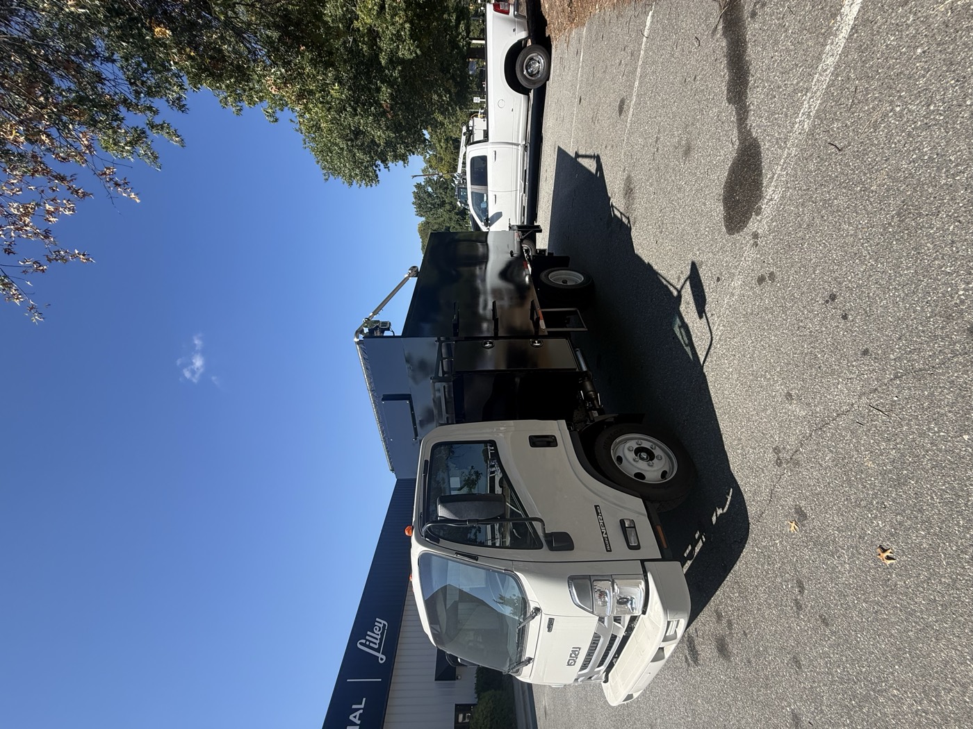 Driver side of the STB body showing the high-mount electric tarp and tool box