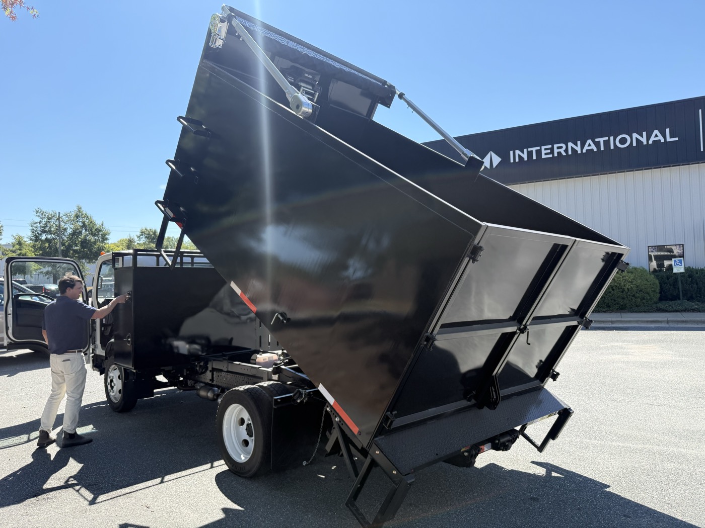STB body raised on its sub-frame hoist, dumping