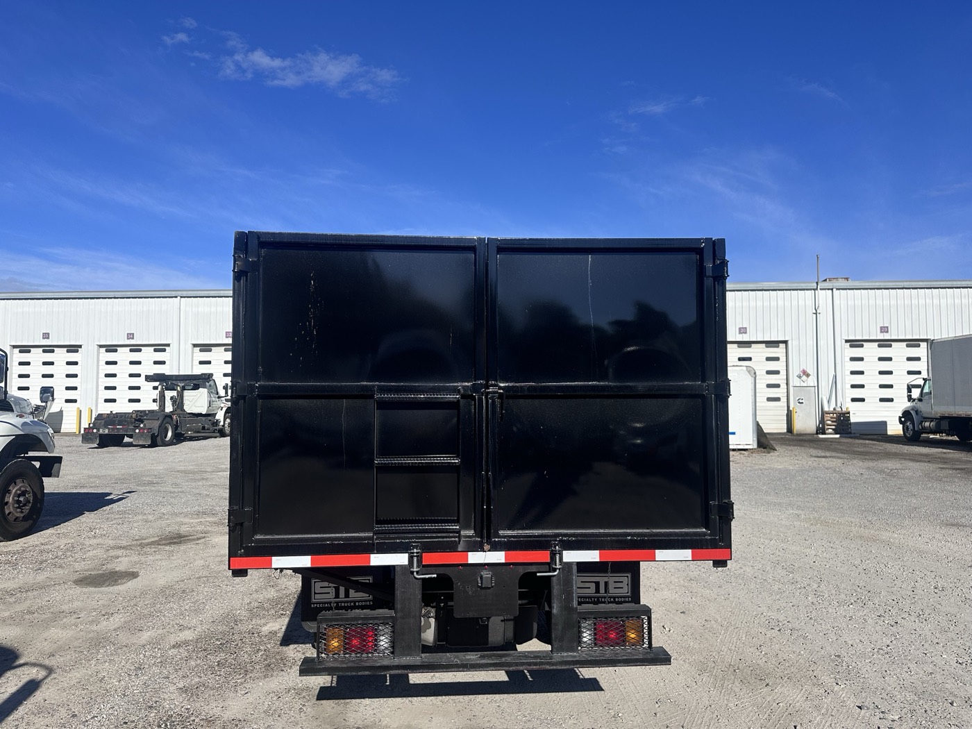 Rear dual barn doors with STB badging on the 2026 Isuzu NPR HD